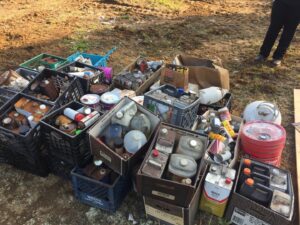 Assorted junk and hazardous waste, including cans and bottles, collected for removal by MLi Environmental in South Portland, ME.
