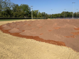 Piles of dirt on an athletic field under construction by Freeman Athletic Fields in Owensboro, KY