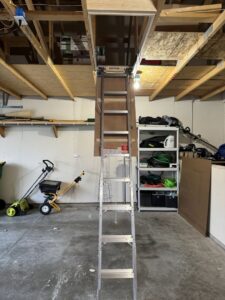 Attic access ladder installation in a garage by Midwest Handyman LLC in West Fargo, ND.