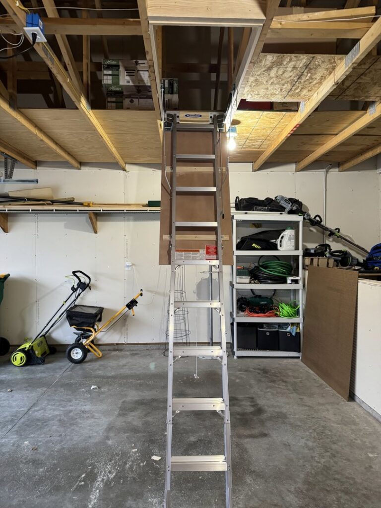 Attic access ladder installation in a garage by Midwest Handyman LLC in West Fargo, ND.