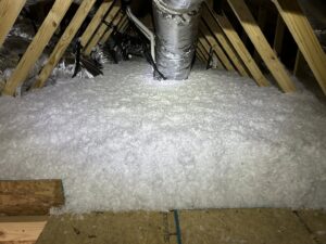 Blown-in insulation covering an attic floor with visible ductwork by Insulation By Cohen's in Moncks Corner, SC.