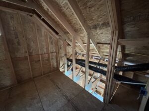 An attic space showing exposed wooden framing and ductwork, often inspected by Pacific Insulation & Mold Remediation in Spokane, WA.