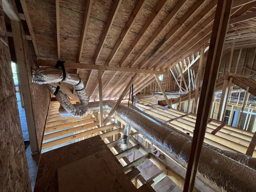 Exposed attic framing and HVAC ductwork installation in a home by Cord Construction in Winchester, KY