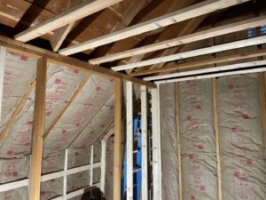 Attic framing and insulation work in progress by Denver House Repair in Lakewood, CO.
