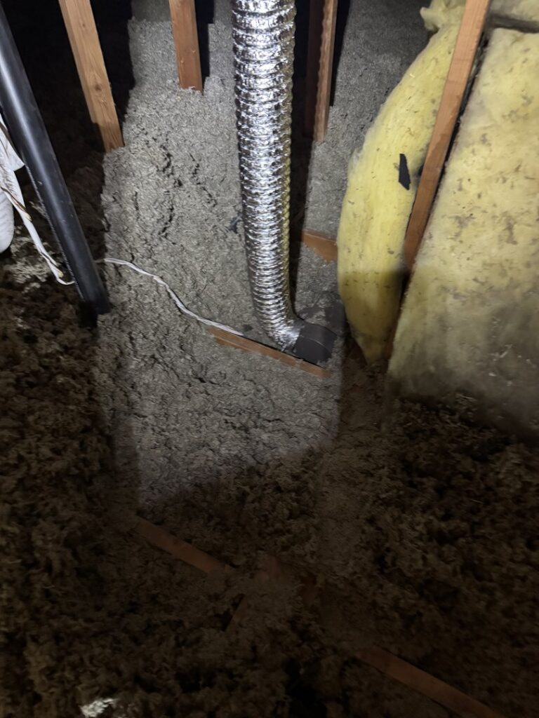 An attic with existing loose insulation and a flexible duct, ready for inspection or upgrade by Pacific Insulation & Mold Remediation in Spokane, WA.