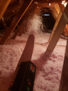 Attic insulation being professionally installed by BEST QUALITY CONSTRUCTION COMPANY in Fountain Valley, CA.