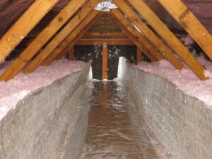 Newly installed insulation and reflective barrier in an attic by Indoor Environmental Systems in Cary, NC.