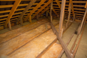 Attic space with new insulation installed between floor joists by Key Insulation in San Antonio, TX.