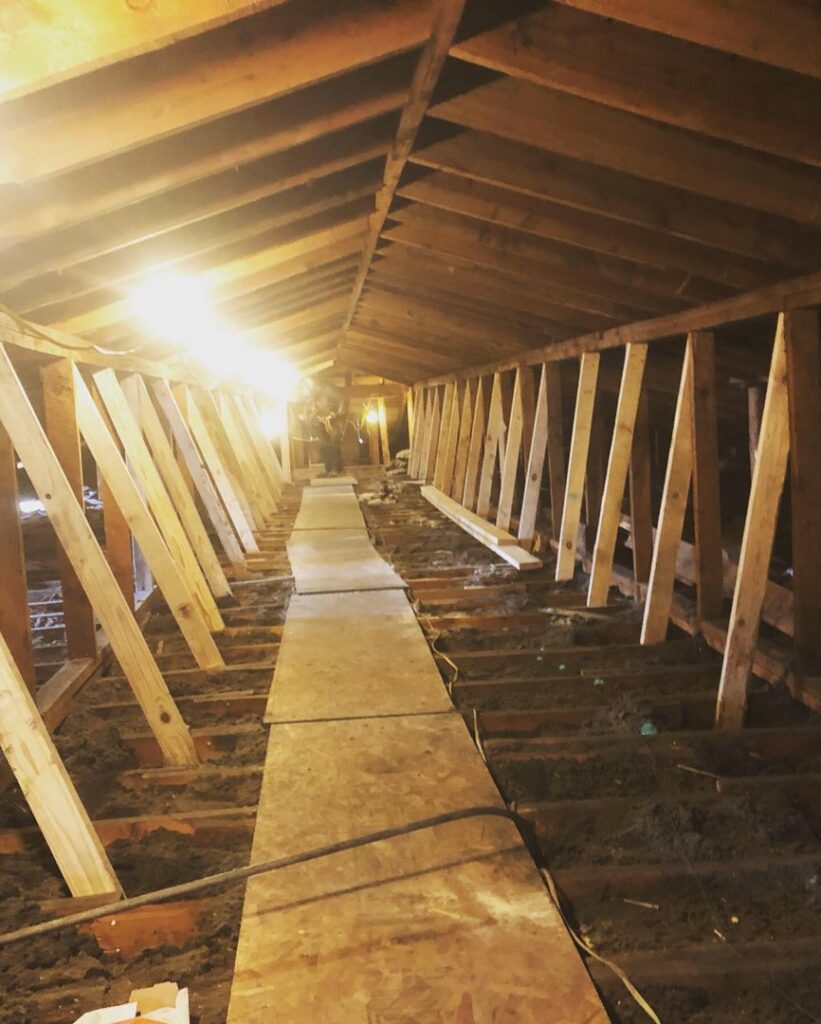 Attic renovation showing exposed rafters and structural work in progress by Deep Roots Craftsmen in Fort Collins, CO.