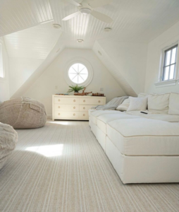 A bright attic room featuring new carpet installation by Williamson Flooring & Design Center in Rock Hill, SC