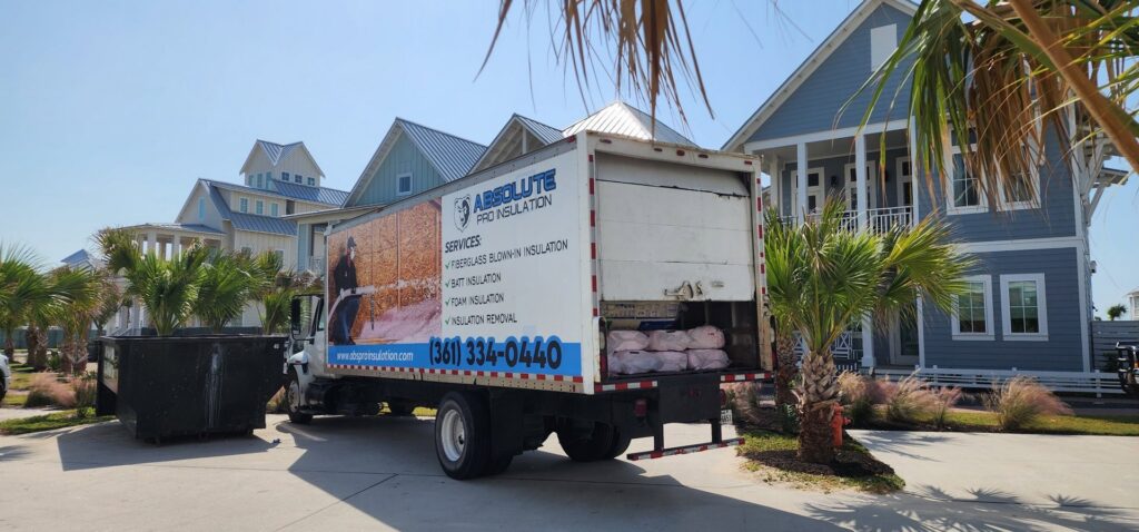 An attic space with spray foam insulation and exposed HVAC ductwork installed by Absolute Pro Insulation in Corpus Christi, TX.