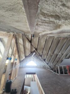 Attic space showing new spray foam insulation installation by FG Drywall, Finishing and Painting in Champaign, IL.