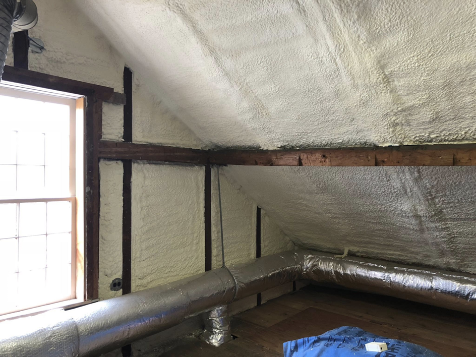 Attic space with new spray foam insulation and ductwork installed by Safco Foam Insulation in Hampden, MA.