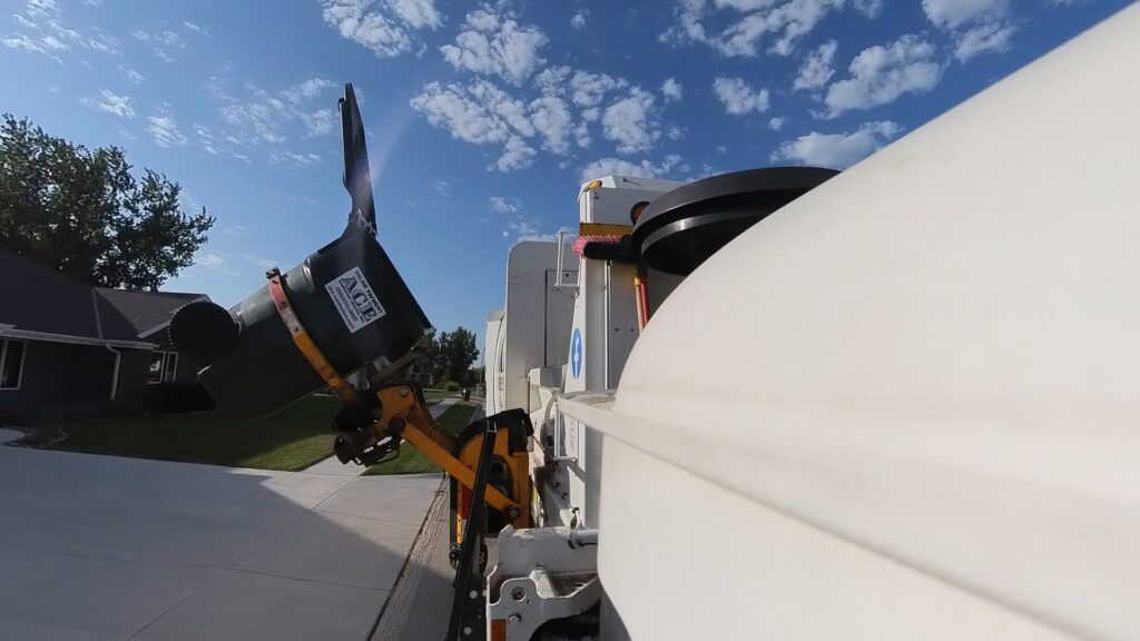 A close-up of an automated arm from an Ace Sanitation Service Inc. truck lifting a trash bin for collection in Columbus, NE.