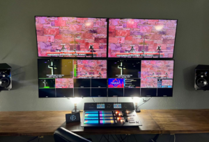 An installed audio visual control room setup with multiple monitors and a mixing console by Simon Pro Audio/Visual Integration in Oklahoma City, OK