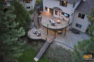 An aerial view of an award-winning multi-level deck with curved design and spiral stairs, built by Ridgeline Decks in Spokane, WA.