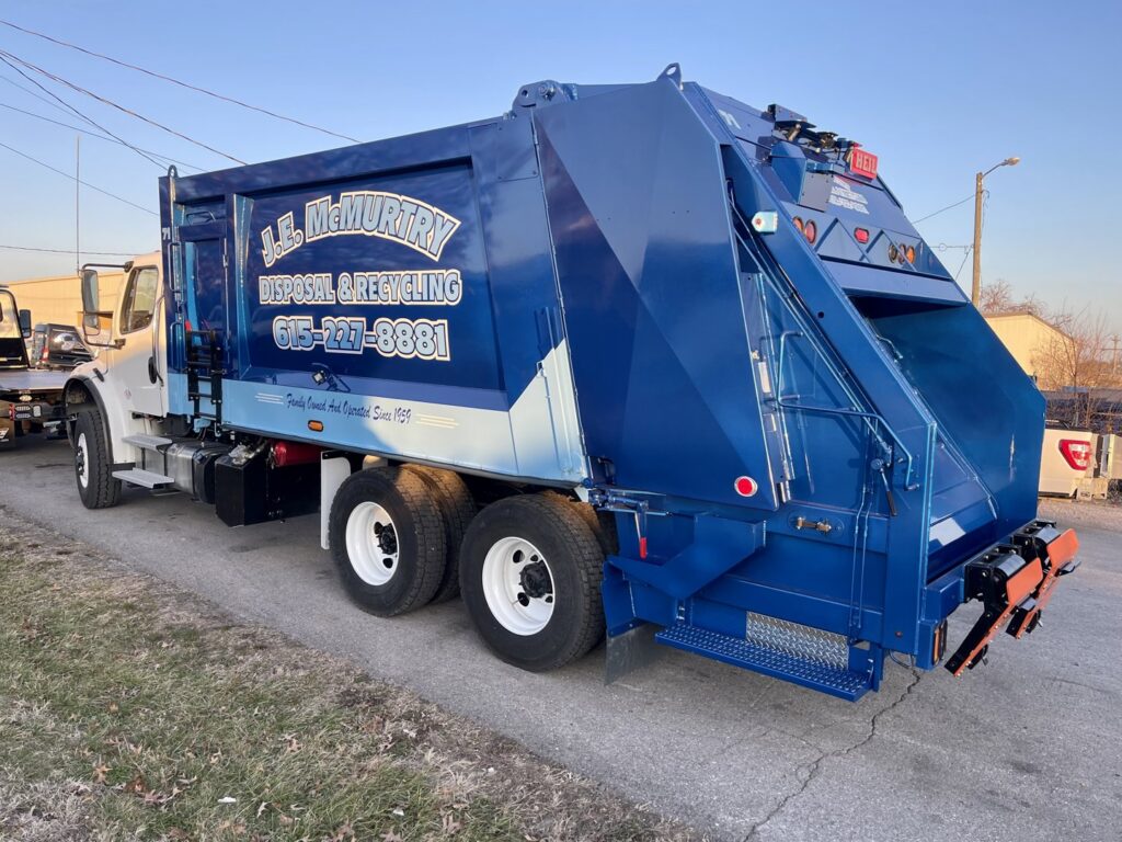 The back of a J.E. McMurtry Disposal & Recycling garbage truck, showcasing their equipment in Nashville, TN.