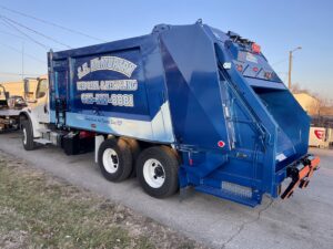 The back of a J.E. McMurtry Disposal & Recycling garbage truck, showcasing their equipment in Nashville, TN.