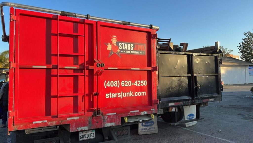 The back of a Stars Junk Removal truck filled with various items of junk, ready for disposal in San Jose, CA.