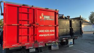 The back of a Stars Junk Removal truck filled with various items of junk, ready for disposal in San Jose, CA.