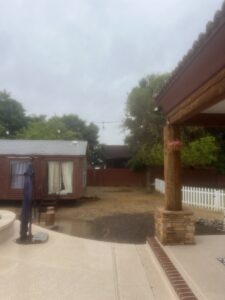 A residential backyard cleared and prepared for new landscaping or tree planting by No Bull Trees in Surprise, AZ.