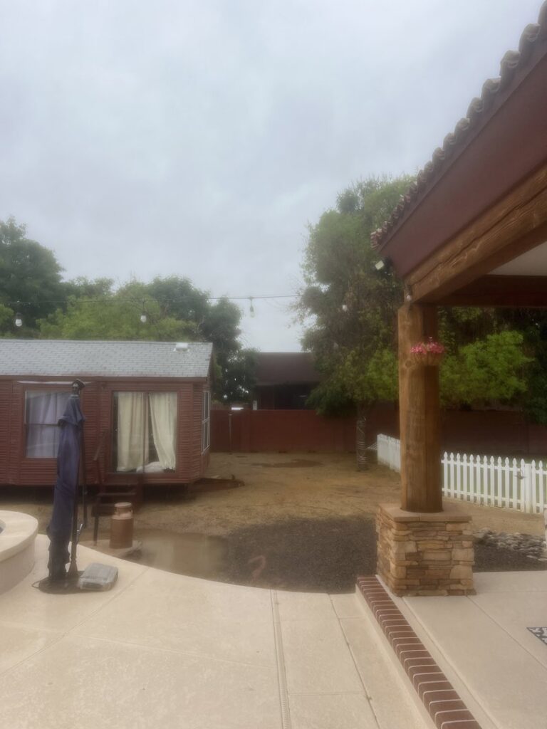 A residential backyard cleared and prepared for new landscaping or tree planting by No Bull Trees in Surprise, AZ.