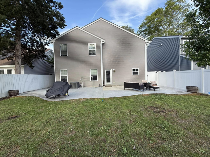 A spacious backyard concrete patio installation completed by McGhee's Concrete in Chesapeake, VA.