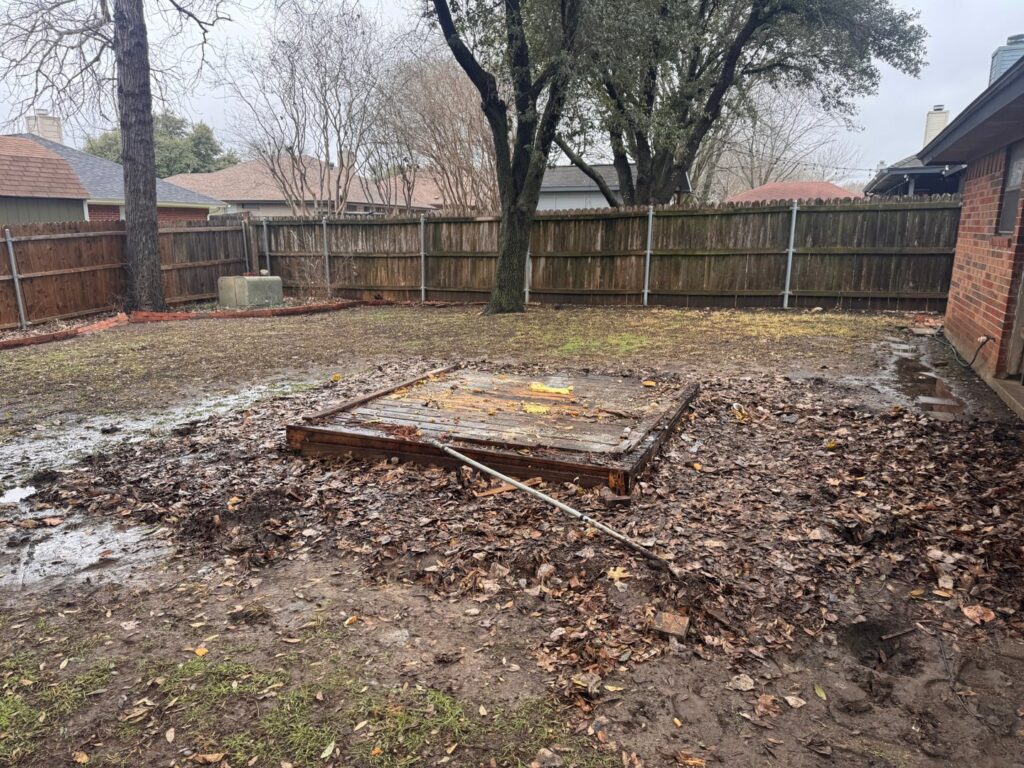 A muddy backyard with fallen leaves and a wooden structure, indicating a need for debris removal by City to City Junk Removal Fort Worth, TX.