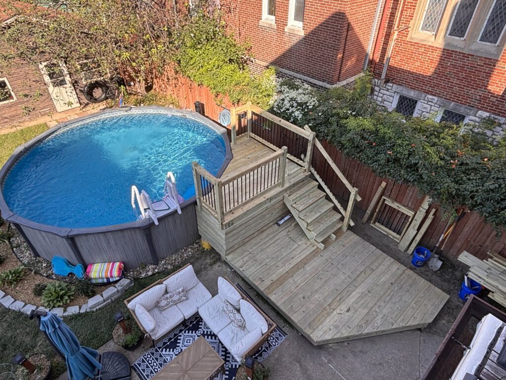 An overhead view of a backyard with a newly built wooden deck and an above-ground pool, a project by McIntosh Construction in Des Peres, MO.