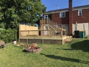 A large backyard deck under construction or newly completed with wooden railings and lattice skirting by Gold-Mine Construction, LLC in Pittsburgh, PA.