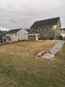 A backyard drainage solution with a gravel path leading to a culvert installed by Drip Dry Drainage in Cramerton, NC.