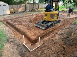 Backyard excavation for a foundation or large trench by Solid Rock Builders in Rock Hill, SC.