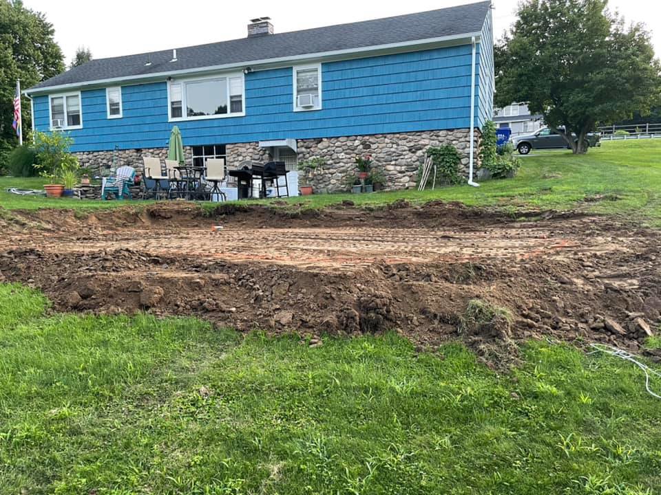 An excavated backyard site, prepared for a new pool installation by Advanced Pools and Repair, LLC in Bristol, CT.