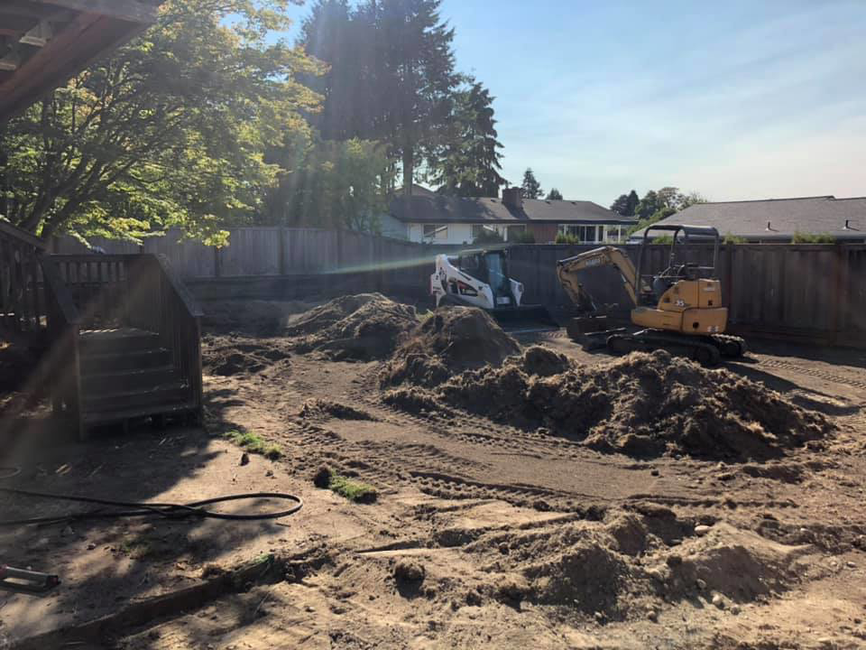 Backyard excavation and site preparation with dirt piles and equipment by M.C.Dirtworks in Caldwell, ID.
