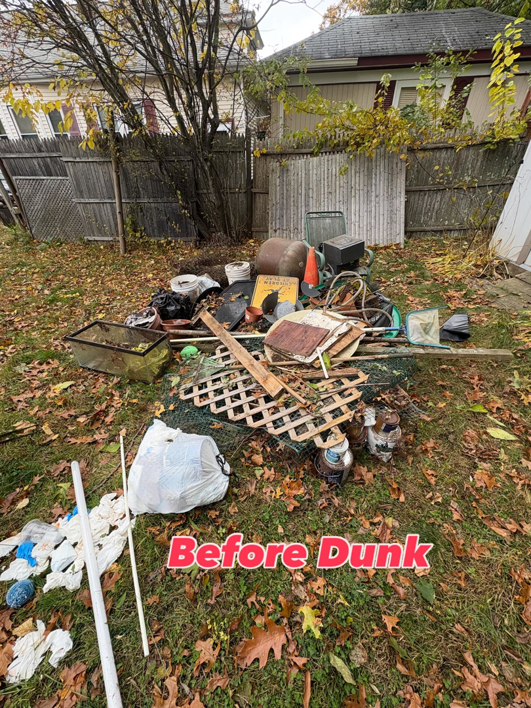 A large pile of assorted junk in a backyard before removal by Junk Dunkers in Wrentham, MA