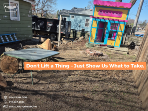 A junk removal truck parked in a backyard with debris, ready for pickup by Siouxland Junk Removal in Sioux City, IA.