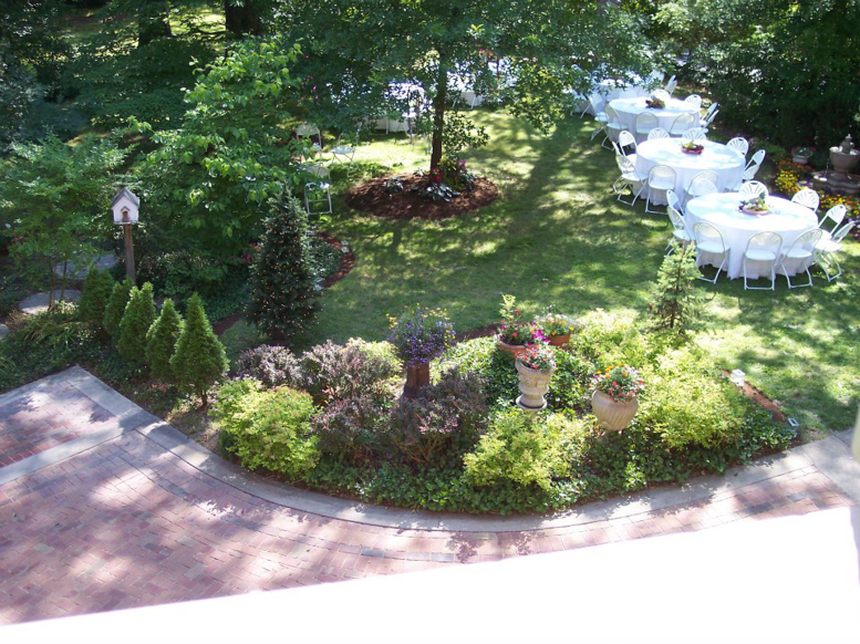 A landscaped backyard with a paved edge and outdoor event setup by Massa Paving Company in Cincinnati, OH.