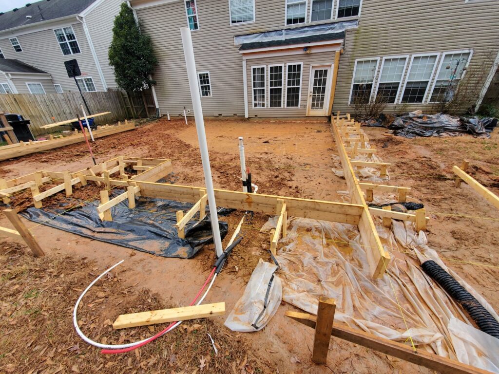 Backyard with concrete forms laid out for a new patio or foundation by GCI Services, Inc. in Simpsonville, SC