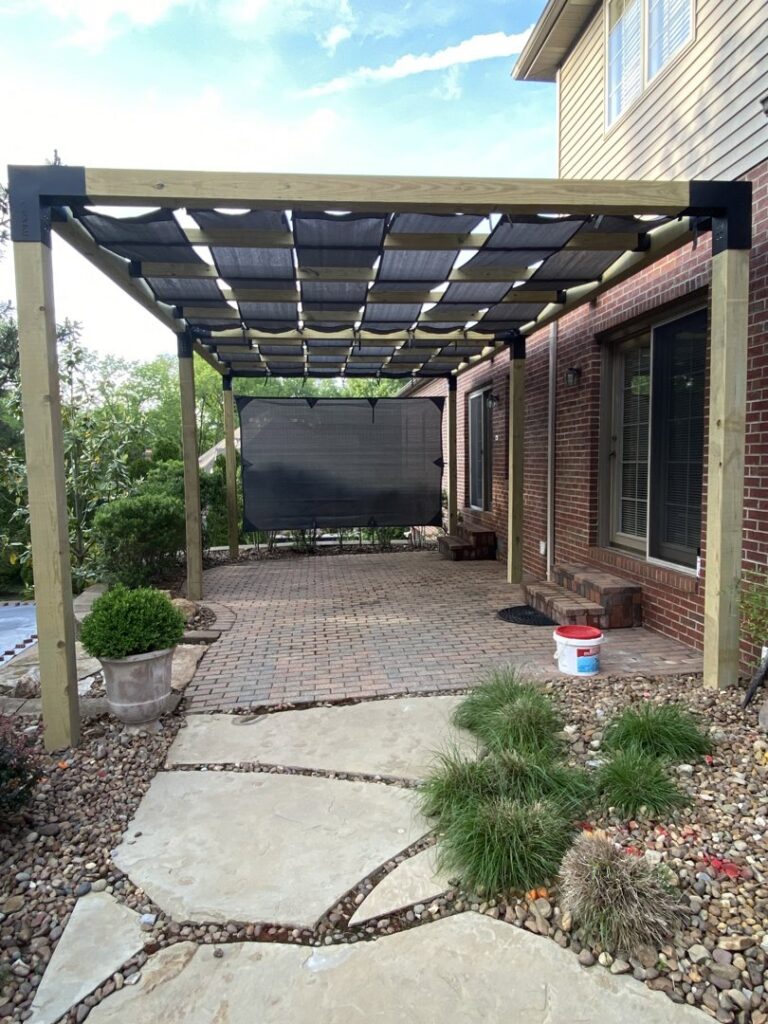 A backyard patio with a newly installed pergola shade structure by ACE Roofing & Construction in Ruskin, FL