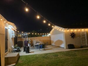 Backyard patio with newly installed string lights by Victor White Handyman in Long Beach, CA
