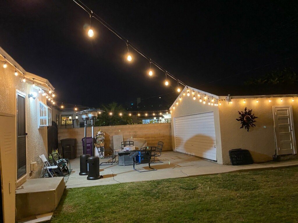 Backyard patio with newly installed string lights by Victor White Handyman in Long Beach, CA