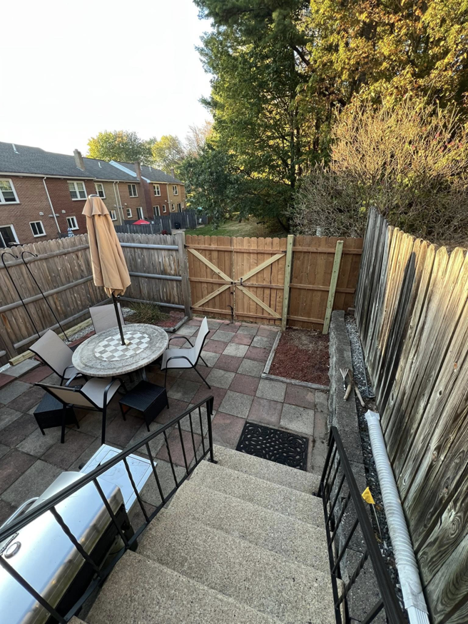 An overhead view of a backyard patio with a wooden privacy fence installed by Fence Masters NH in Concord, NH.