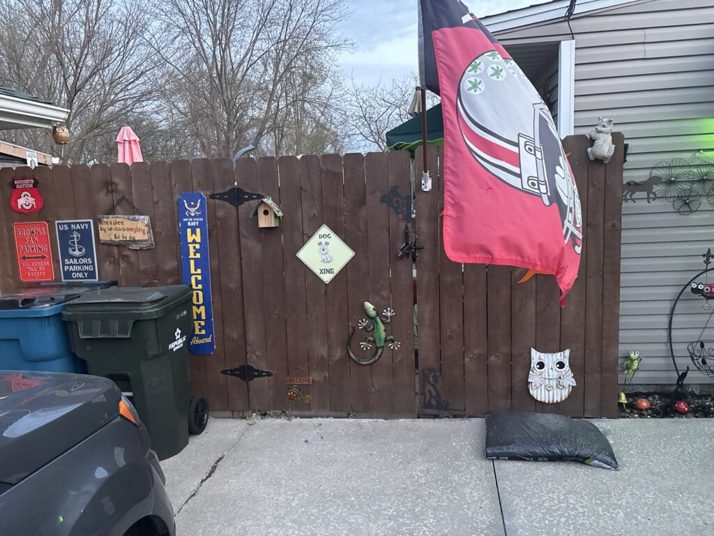 A new wooden picket fence installation in a backyard by Ofandiski Fence Co. Inc in Lorain, OH.