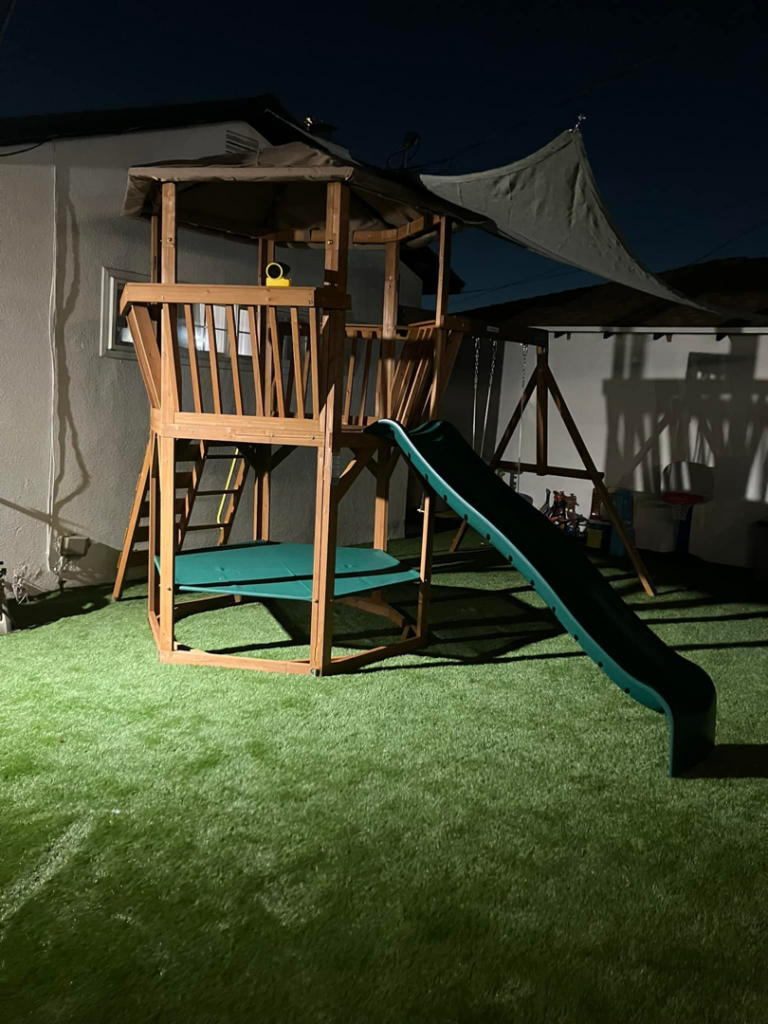 A newly assembled wooden backyard playset by Grade A Handyman in Lancaster, CA.