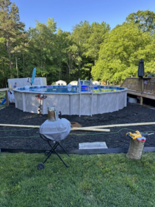 A backyard above-ground pool area with fresh landscaping mulch, part of a project by Fence&Wash in Rock Hill, SC.
