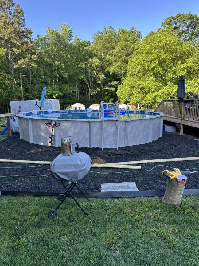 A backyard above-ground pool area with fresh landscaping mulch, part of a project by Fence&Wash in Rock Hill, SC.