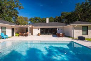 A backyard with a newly installed swimming pool and patio by All Star Construction, Inc. in Houston, TX.