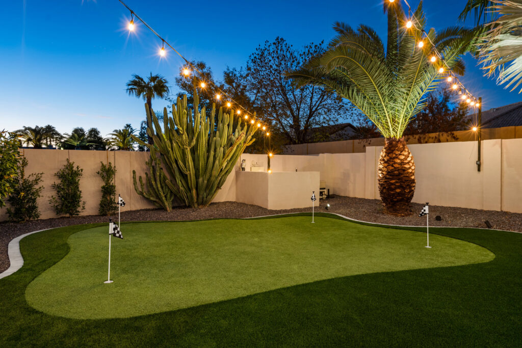 A backyard putting green installation by Envy Pools in Gilbert, AZ.