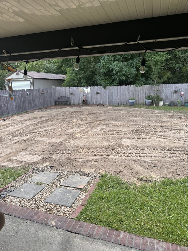 A backyard site completely cleared and leveled after junk removal by Weekly Waste Solutions in Jackson, MS.