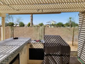 A residential backyard showing newly planted trees, demonstrating tree planting services by No Bull Trees in Surprise, AZ.